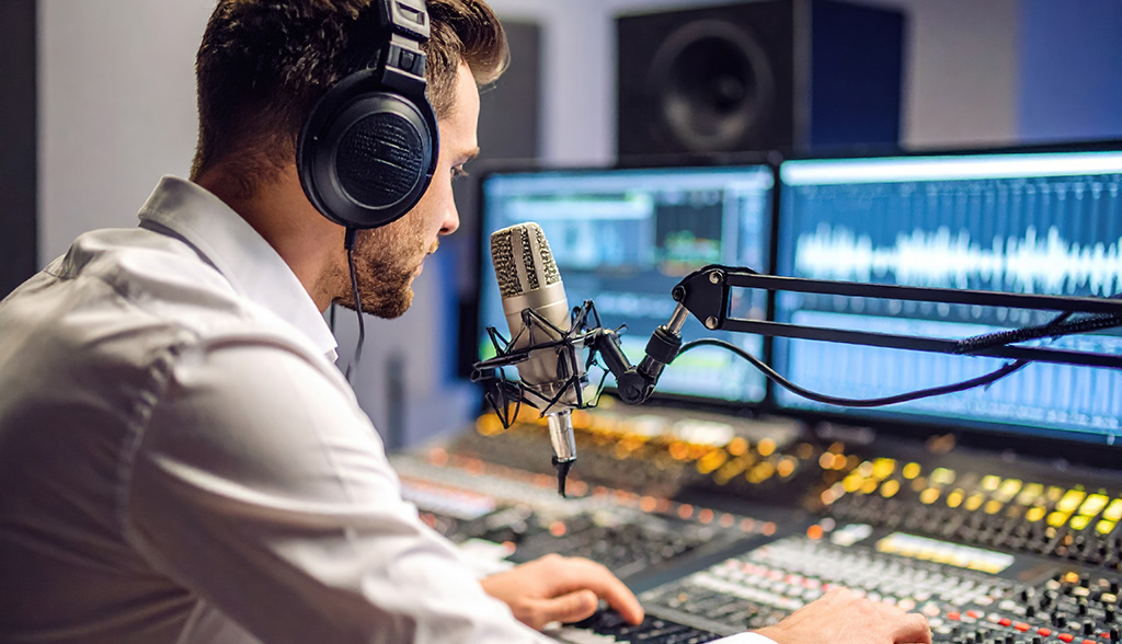 Young radio host broadcasting in modern studio, focused on mixing audio with high fidelity equipment. atmosphere is creative and energetic, showcasing art of sound production